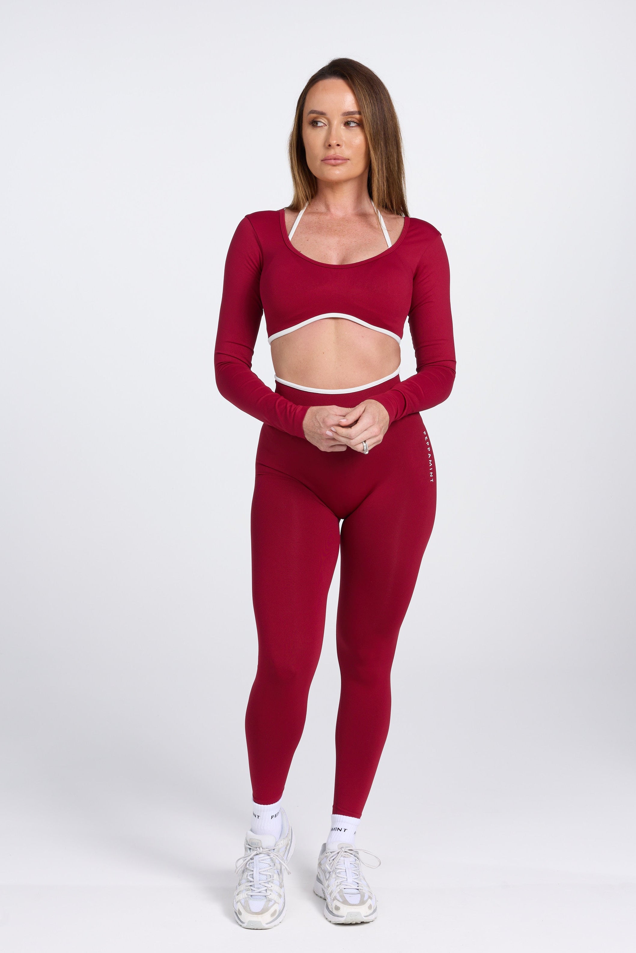 Long sleeve seamless crop top, with built in white contrasting bra, luxe white trim, and adjustable halter strap in wine colour.