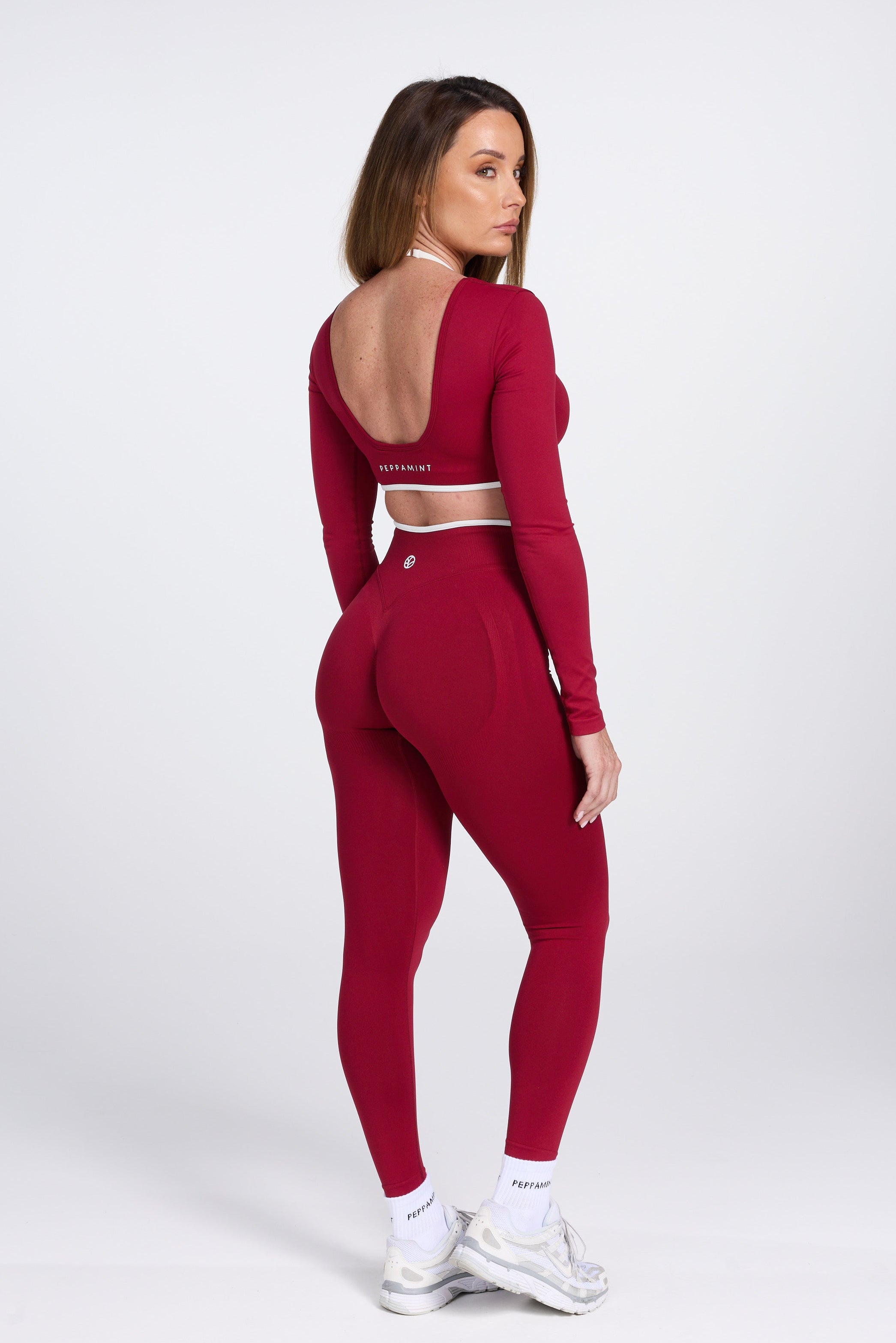 Long sleeve seamless crop top, with built in white contrasting bra, luxe white trim, and adjustable halter strap in wine colour.