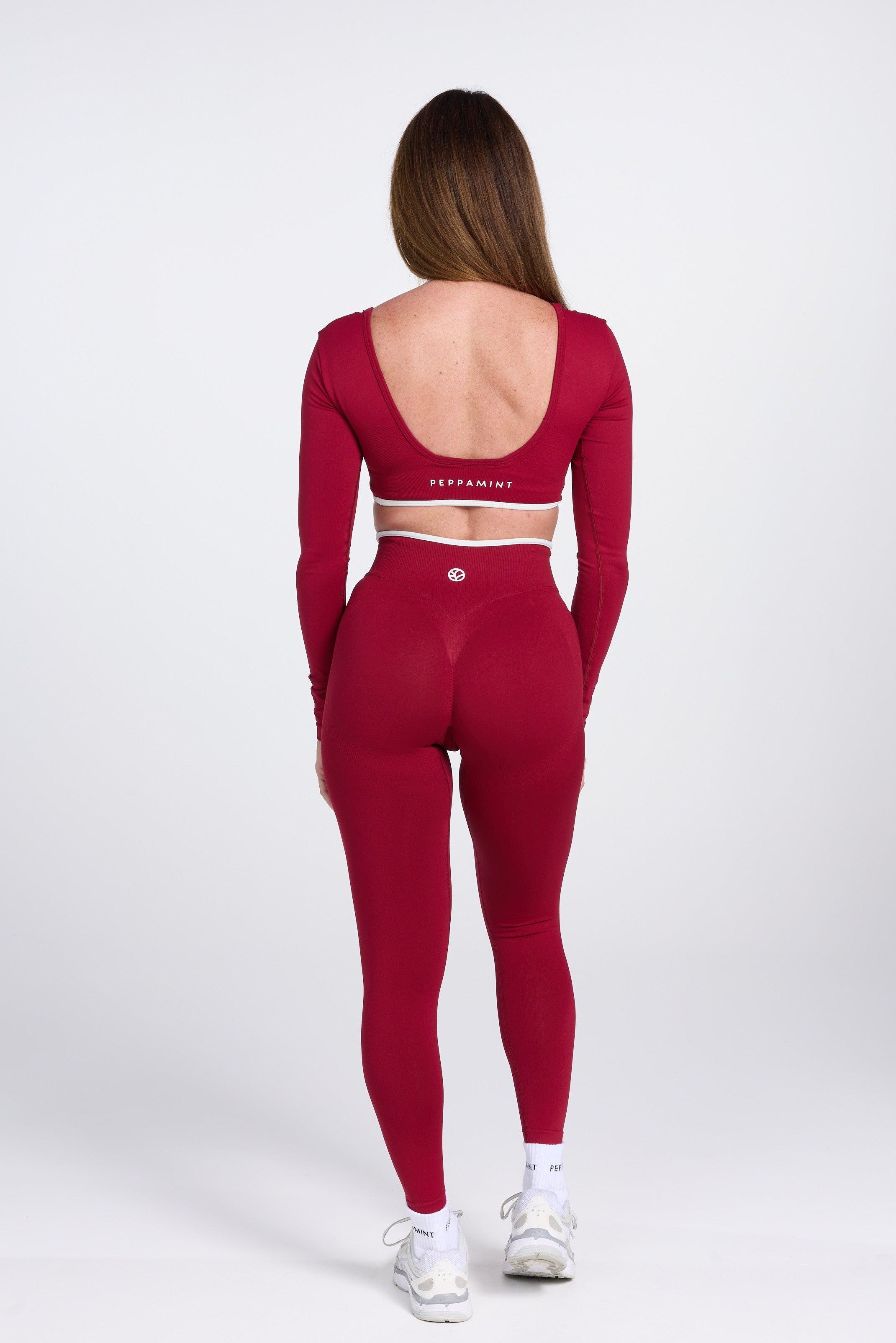 Long sleeve seamless crop top, with built in white contrasting bra, luxe white trim, and adjustable halter strap in wine colour.