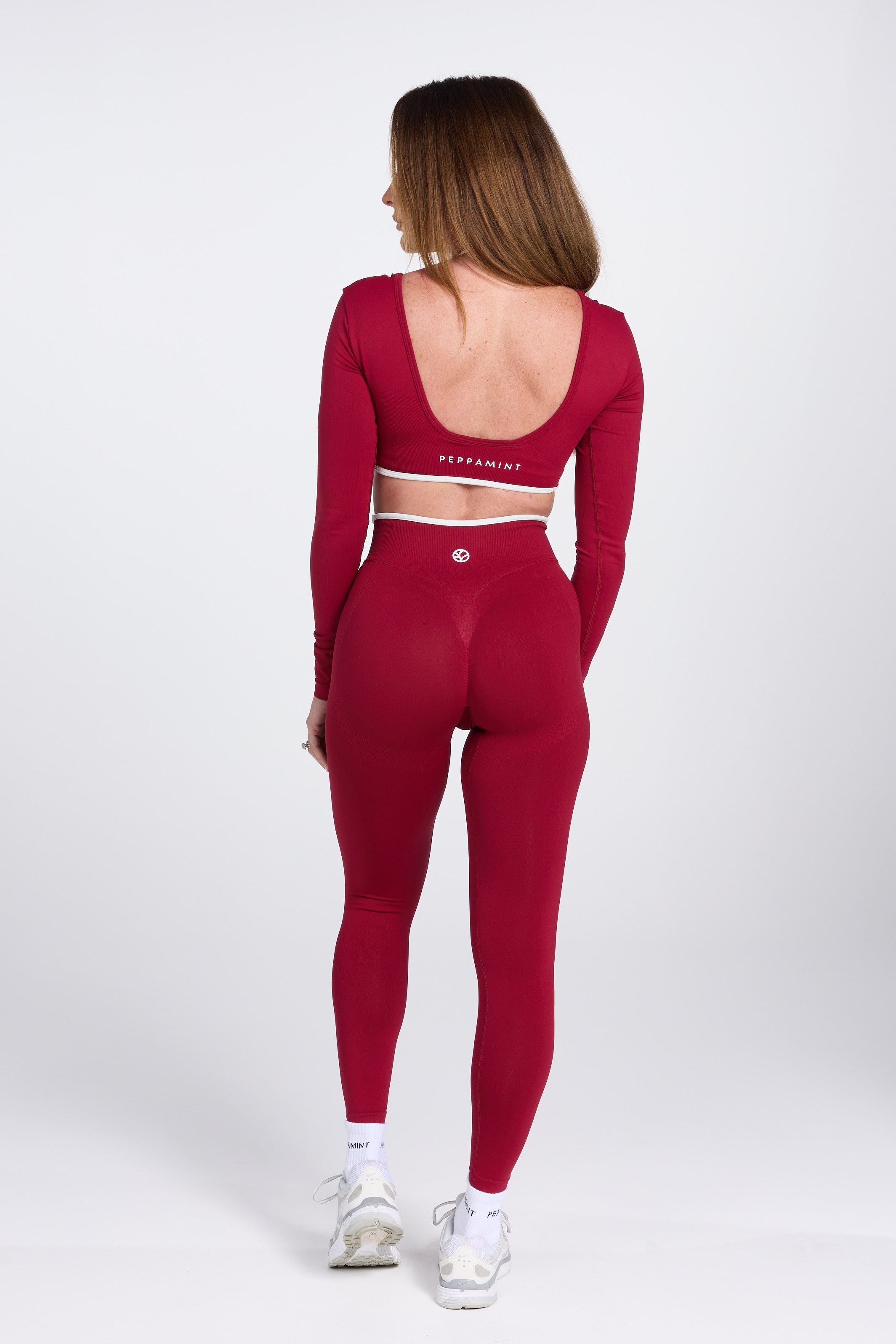 Long sleeve seamless crop top, with built in white contrasting bra, luxe white trim, and adjustable halter strap in wine colour.