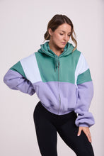 Load image into Gallery viewer, Hip length, full zip hoodie, with ribbed panels, embossed sleeve logo, in a slouchy oversize fit, in green, lavender and white.
