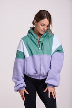 Load image into Gallery viewer, Hip length, full zip hoodie, with ribbed panels, embossed sleeve logo, in a slouchy oversize fit, in green, lavender and white.

