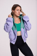 Load image into Gallery viewer, Hip length, full zip hoodie, with ribbed panels, embossed sleeve logo, in a slouchy oversize fit, in green, lavender and white.
