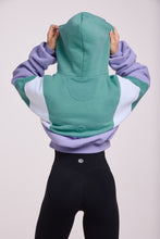 Load image into Gallery viewer, Hip length, full zip hoodie, with ribbed panels, embossed sleeve logo, in a slouchy oversize fit, in green, lavender and white.
