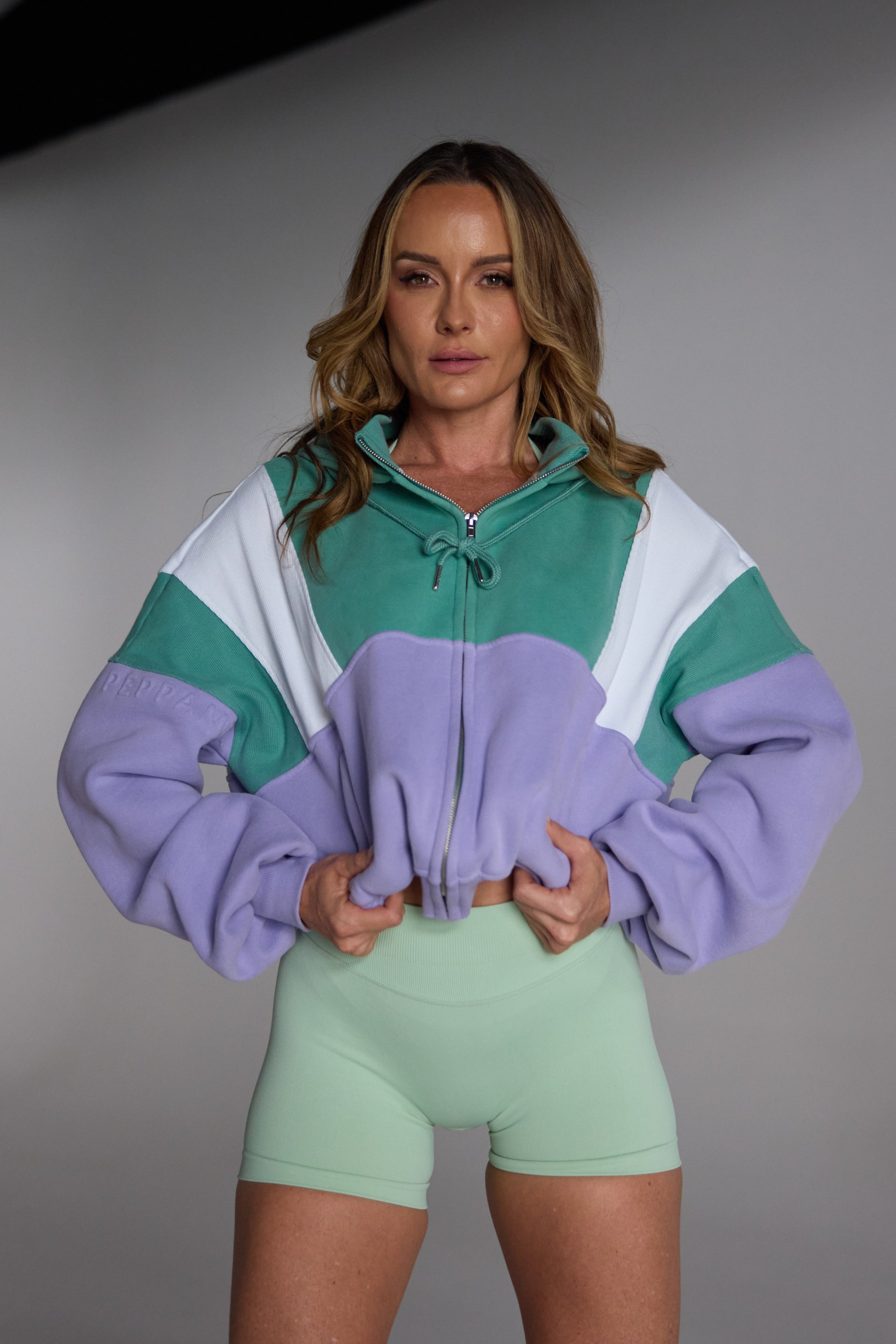 Hip length, full zip hoodie, with ribbed panels, embossed sleeve logo, in a slouchy oversize fit, in green, lavender and white.