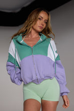 Load image into Gallery viewer, Hip length, full zip hoodie, with ribbed panels, embossed sleeve logo, in a slouchy oversize fit, in green, lavender and white.

