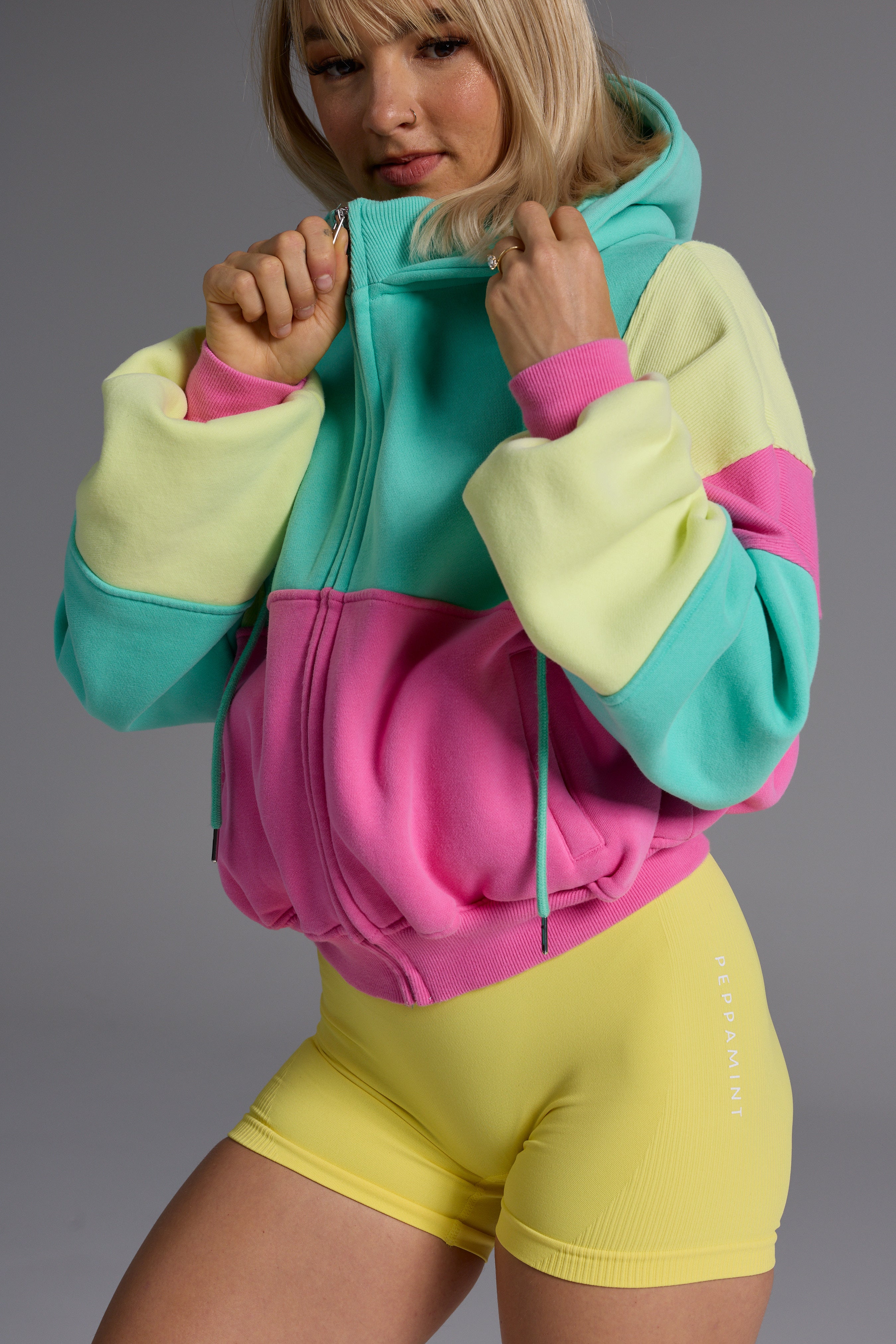 Hip length, full zip hoodie, with ribbed panels, embossed sleeve logo, in a slouchy oversize fit, with 2 convenient zip pockets, in neon pink, green and yellow.