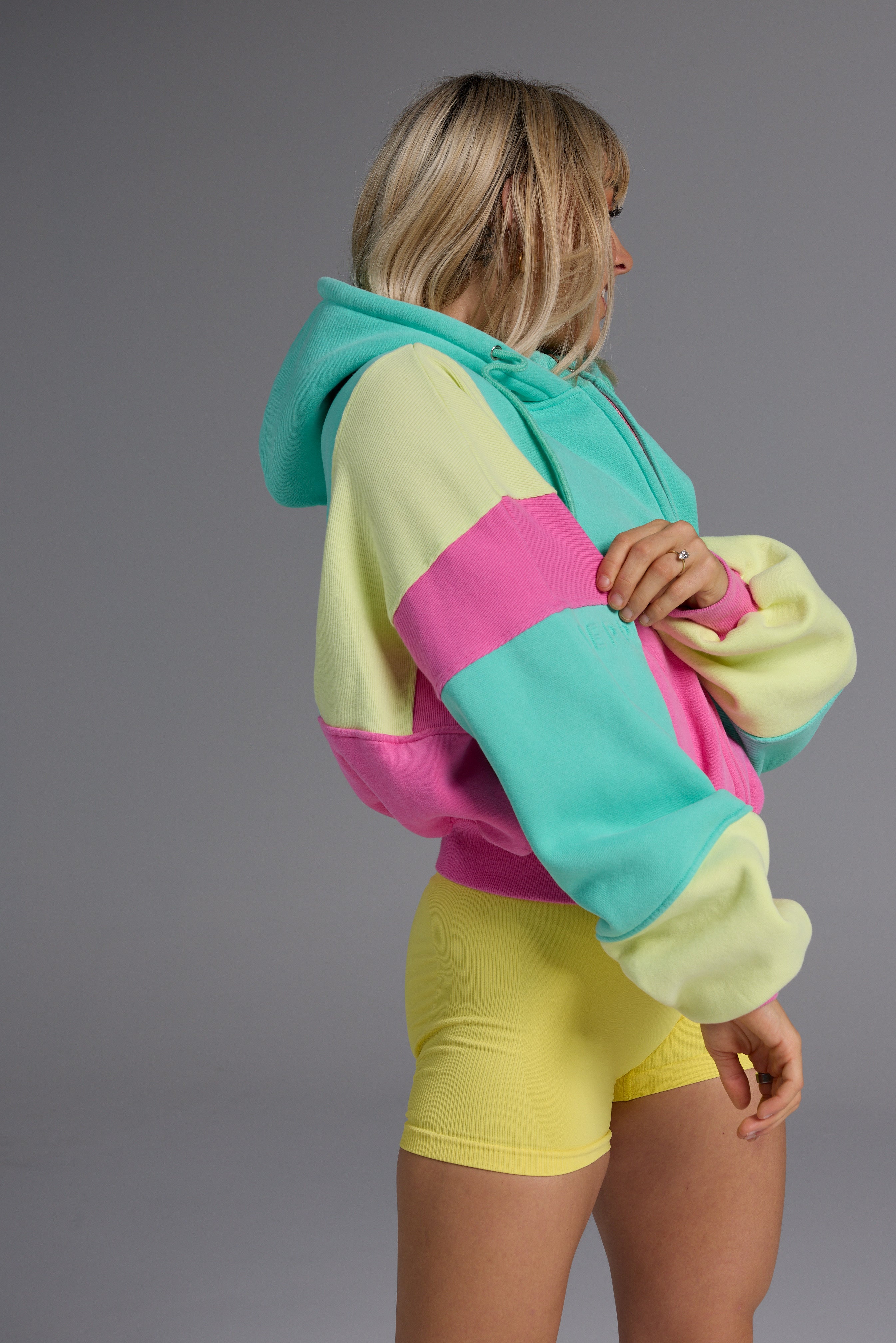 Hip length, full zip hoodie, with ribbed panels, embossed sleeve logo, in a slouchy oversize fit, with 2 convenient zip pockets, in neon pink, green and yellow.