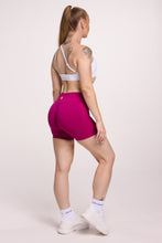 Load image into Gallery viewer, Front cross over strap activewear bra in seamless fabric with adjustable back straps, and ribbed supportive underbust band in white and seamless gym tights with booty contouring panels, invisible scrunch technology, sweetheart shaped back seams and thick supportive fabric in magenta pink
