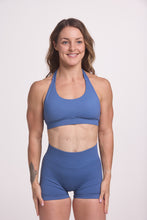 Load image into Gallery viewer, Seamless halter bra with a thick supportive fabric blend and a branded back strap, with a ribbed elastic hem and seamless gym tights with booty contouring panels, invisible scrunch technology, sweetheart shaped back seams and thick supportive fabric in grey blue colour
