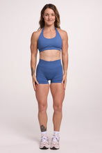 Load image into Gallery viewer, Seamless halter bra with a thick supportive fabric blend and a branded back strap, with a ribbed elastic hem and seamless gym tights with booty contouring panels, invisible scrunch technology, sweetheart shaped back seams and thick supportive fabric in grey blue colour
