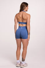 Load image into Gallery viewer, Seamless halter bra with a thick supportive fabric blend and a branded back strap, with a ribbed elastic hem and seamless shorts with booty contouring panels, invisible scrunch technology, a sweetheart shaped back seam, and a thick supportive waistband in grey blue colour
