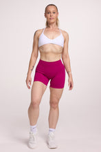 Load image into Gallery viewer, Minimalistic bra with breast contouring panels and a ruched front seam to effortlessly shape the breasts, with a sleek back straps and halter neck design in white and seamless gym tights with booty contouring panels, invisible scrunch technology, sweetheart shaped back seams and thick supportive fabric in magenta colour

