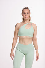 Load image into Gallery viewer, Front cross over strap activewear bra in seamless fabric with adjustable back straps, and ribbed supportive under bust band with seamless gym tights with booty contouring panels, invisible scrunch technology, sweetheart shaped back seams and thick supportive fabric in mist green

