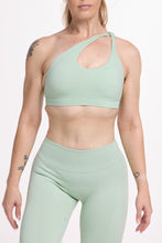 Load image into Gallery viewer, Front cross over strap activewear bra in seamless fabric with adjustable back straps, and ribbed supportive under bust band with seamless gym tights with booty contouring panels, invisible scrunch technology, sweetheart shaped back seams and thick supportive fabric in mist green
