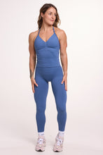 Load image into Gallery viewer, Halter neck tank top with breast contouring panels and a ruched front seam, a built in bra, and an open upper back design and seamless gym tights with booty contouring panels, invisible scrunch technology, sweetheart shaped back seams and thick supportive fabrics in grey blue colour
