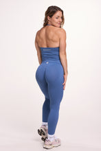 Load image into Gallery viewer, Halter neck tank top with breast contouring panels and a ruched front seam, a built in bra, and an open upper back design and seamless gym tights with booty contouring panels, invisible scrunch technology, sweetheart shaped back seams and thick supportive fabrics in grey blue colour 
