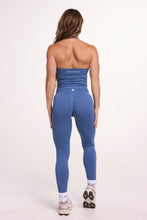 Load image into Gallery viewer, Halter neck tank top with breast contouring panels and a ruched front seam, a built in bra, and an open upper back design and seamless gym tights with booty contouring panels, invisible scrunch technology, sweetheart shaped back seams and thick supportive fabrics in grey blue colour

