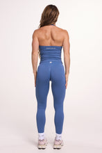 Load image into Gallery viewer, Halter neck tank top with breast contouring panels and a ruched front seam, a built in bra, and an open upper back design and seamless gym tights with booty contouring panels, invisible scrunch technology, sweetheart shaped back seams and thick supportive fabrics in grey blue colour 

