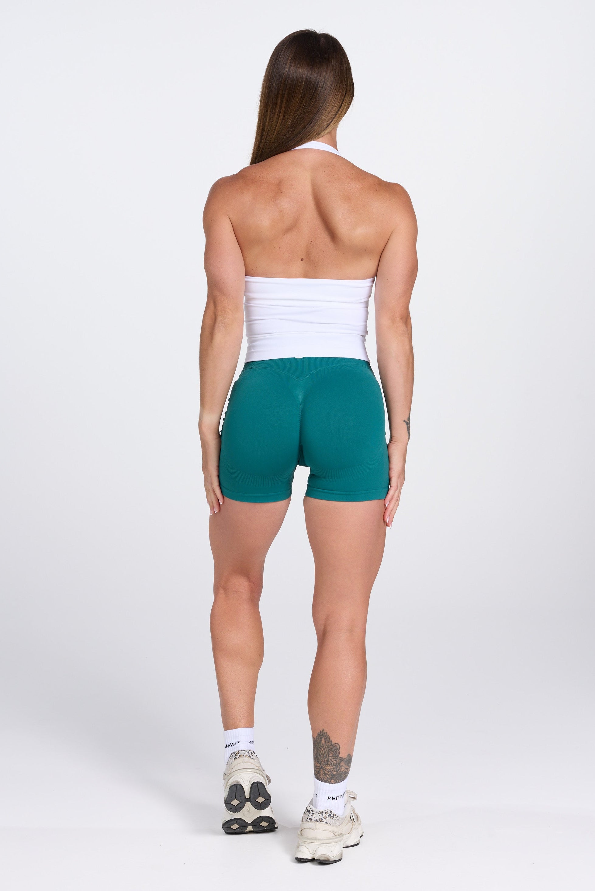 Seamless halter neck tank top, with supportive built in bra, U neck design and open back, with PEPPAMINT centre chest branding in white